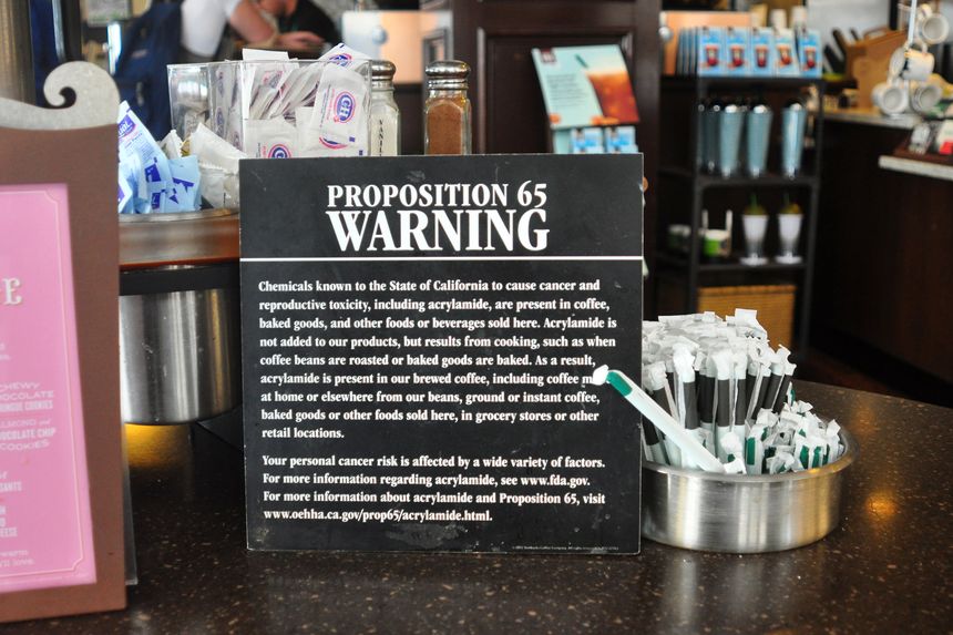 picture of a cancer warning placard in a coffee shop