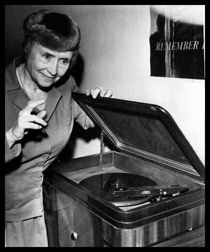 Helen Keller listening to a phonograph with her fingertips